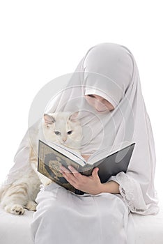 Pretty Muslim Girl and Cat Reading Holy Book of Quran