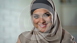 Pretty muslim housewife in her 30s looking at camera, female wellness, happiness