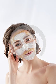 Pretty naked smiling woman with face mask