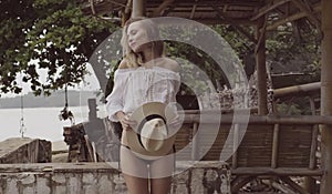 Pretty naturally looking woman on summer day with straw hat