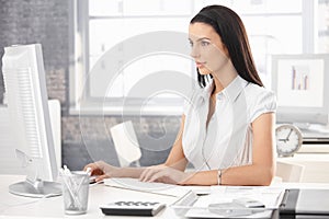 Pretty office worker at desk