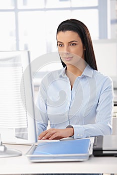 Pretty office worker at desk