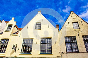 Pretty old white houses Bruges city view at summer day Belgium