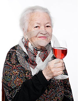 Pretty old woman with glass of wine