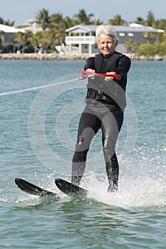 Pretty Older Lady Water Skiing by Nice House.