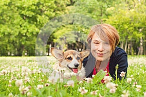 Pretty older woman with her dog in the park on a sunny day