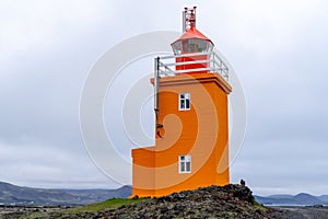 Pretty orange Hopsnes Lighthouse near Grindavik, Iceland on the Reykjanes Peninsula