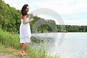 Pretty girl walking by water