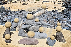 Pretty pile of wooden pebbles and balls of sand facing the sea