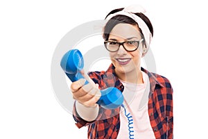 Pretty pin-up girl wearing glasses offering blue receiver