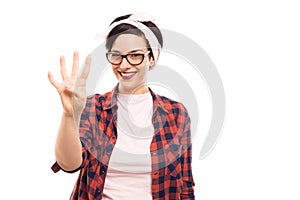 Pretty pin-up girl wearing glasses showing number four with fingers.