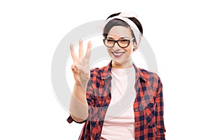 Pretty pin-up girl wearing glasses showing number three with fin