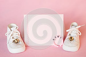 Pretty Pink Baby Girl Shower Invitation Card or Birth Announcement with vintage white shoes on Pink Cloth Background with room or