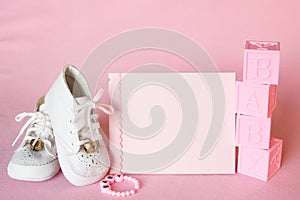 Pretty Pink Baby Girl Shower Invitation Card or Birth Announcement with vintage white shoes on Pink Cloth Background with room or photo