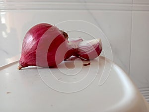 Pretty Pink colored peeled and fresh spicy onion cut three part cut