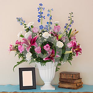 Pretty Pink and Lavender Flower Bouquet in White Vase with Blank Picture Frame and Vintage Books with room or space for your words