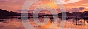 Pretty Pink orange Sky cloudscape over an island