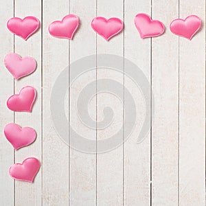 Pretty Pink Valentines Day hearts on White wood Boards Background with a Shabby Chic Style.  It`s a square with copy space in the