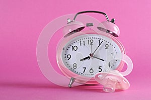 Pretty pink vintage retro style alarm clock with baby dummy pacificer