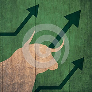 Pretty portrait bull and a upward arrow indicating the up of the stock market green background, stock market up and bull concept.