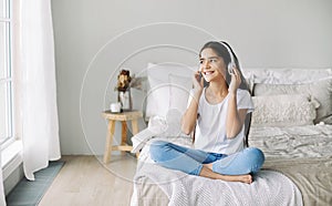Pretty pre-teen girl listen music through wireless headphones