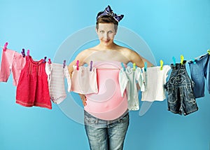 Pretty pregnant mom doing the laundry