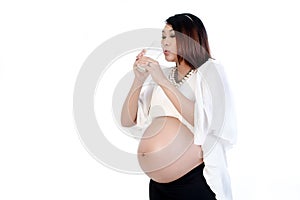 Pretty pregnant woman drinking glass of milk