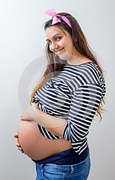 Pretty pregnant woman holding belly