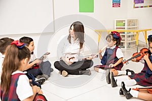 Happy music teacher in preschool