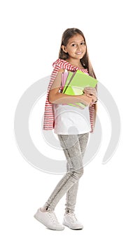 Pretty preteen girl with notebooks against white