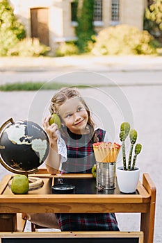 Pretty Primary Schoolgirl Sit At Desk Outside