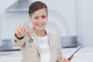 Pretty real estate agent giving house key