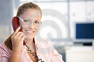 Pretty receptionist working talking on phone