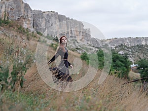 pretty redhead woman in black dress walk landscape freedom