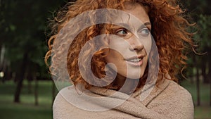 pretty redhead woman covered in blanket