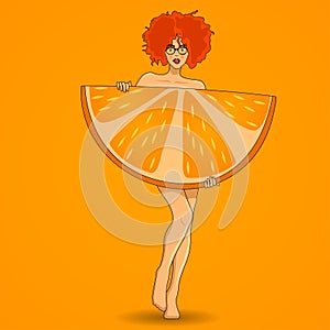 Pretty redhead woman poses with big orange