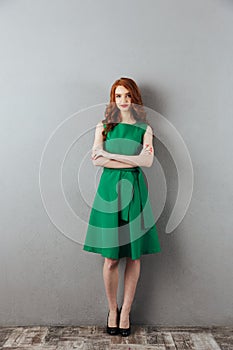 Pretty redhead young lady in green dress