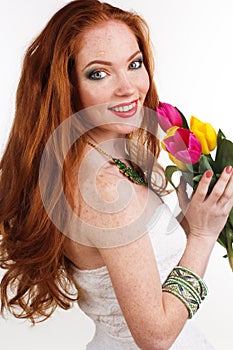 Pretty redheaded girl with bouquet of tulips