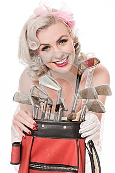 Pretty retro girl with golf clubs and red golf bag, isolated on