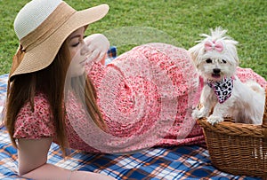 Pretty romantic girl with Maltese puppy