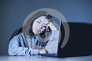 Pretty sad Asian Korean student woman looking depressed and worried studying with laptop computer in stress for exam feeling bored