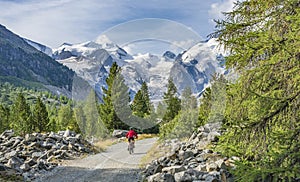 Pretty senior Woman on electric bicycle in Engadin valley, Switzerland