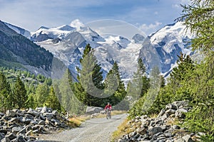 Pretty senior Woman on electric bicycle in Engadin valley, Switzerland