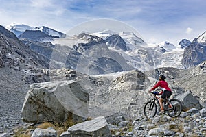 Pretty senior Woman on electric bicycle in Engadin valley, Switzerland