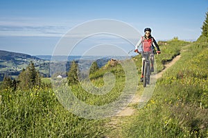 Pretty senior Woman on electric bicycle in Engadin valley, Switzerland