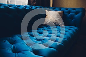 Pretty simple decor of living room with blue sofa and light.