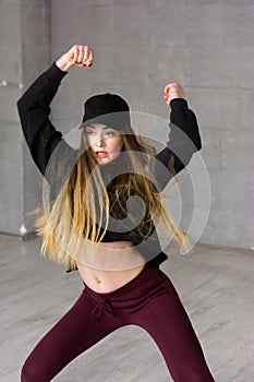 Pretty slim modern style dancer in movement.