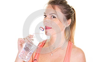 Pretty slim sporty woman female athlete drinking water