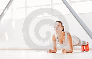 Pretty slim woman concentrating on the physical activity