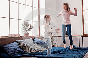 Pretty small girls jumping on the bed